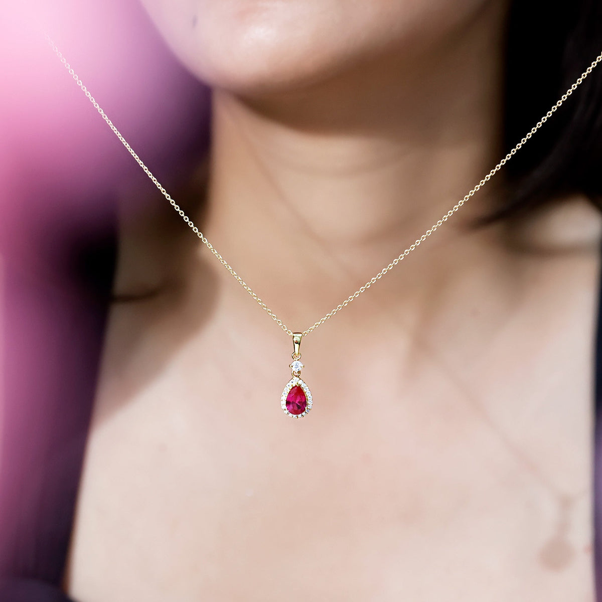 Lab created ruby teardrop pendant with moissanite halo from Rosec Jewels, featuring a sparkling gemstone and elegant design.