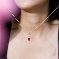 Lab created ruby teardrop pendant with moissanite halo from Rosec Jewels, featuring a sparkling gemstone and elegant design.