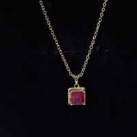 Yellow gold princess cut lab-created ruby solitaire pendant with rope frame by Rosec Jewels, showcasing a sparkling gemstone and elegant design.