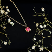 Rosec Jewels princess cut lab-created ruby solitaire pendant with rope frame, showcasing a sparkling red gemstone and elegant design.