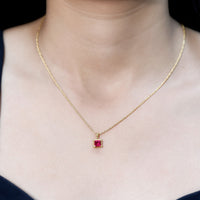 Rosec Jewels princess cut lab-created ruby solitaire pendant with rope frame, showcasing the elegant jewelry design and vibrant gemstone.