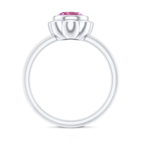 Pink tourmaline flower engagement ring with a 1 carat round pink gemstone set in a delicate ring band.