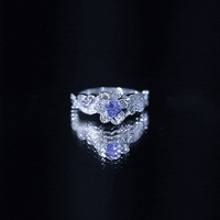 Certified Tanzanite and diamond flower engagement ring in silver featuring a floral design with sparkling stones, by Rosec Jewels.