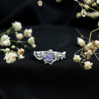 Certified Tanzanite and diamond flower engagement ring in silver, featuring a floral design with sparkling gemstones.