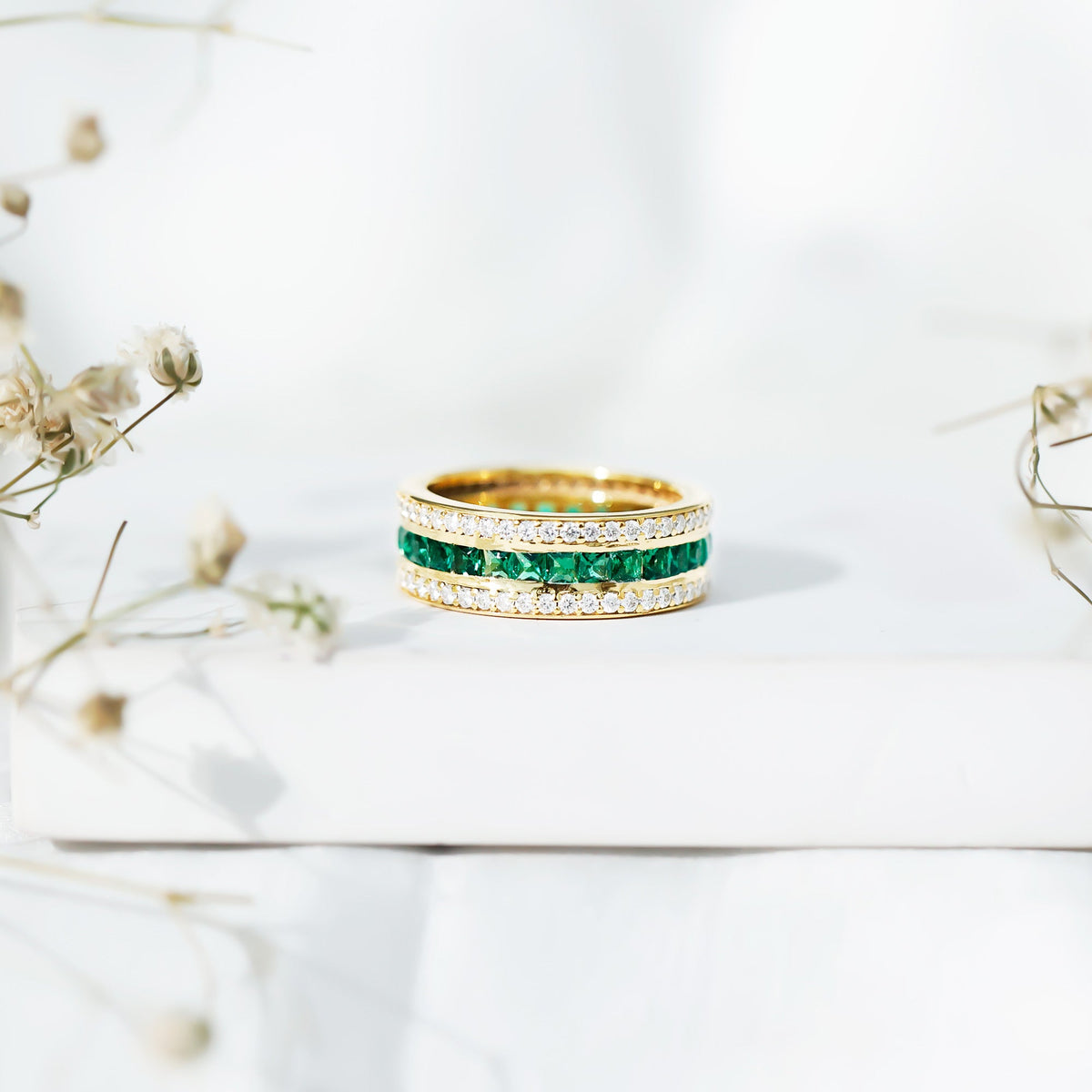 Certified lab-grown emerald 3-row eternity wedding band ring by Rosec Jewels with sparkling green gemstones.