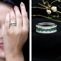Lab-grown emerald eternity wedding band with three rows of sparkling emeralds, crafted by Rosec Jewels.
