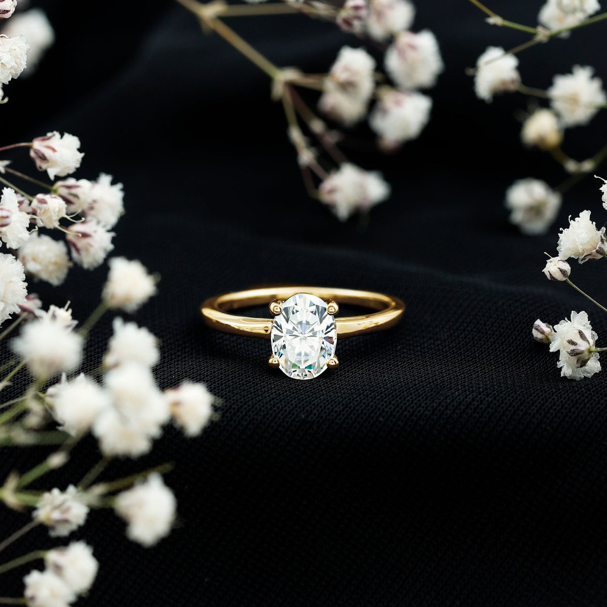 Oval Moissanite engagement ring with a 6x8mm solitaire stone, set in a rose gold band by Rosec Jewels.