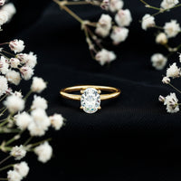 Oval Moissanite engagement ring with a 6x8mm solitaire stone, set in a rose gold band by Rosec Jewels.