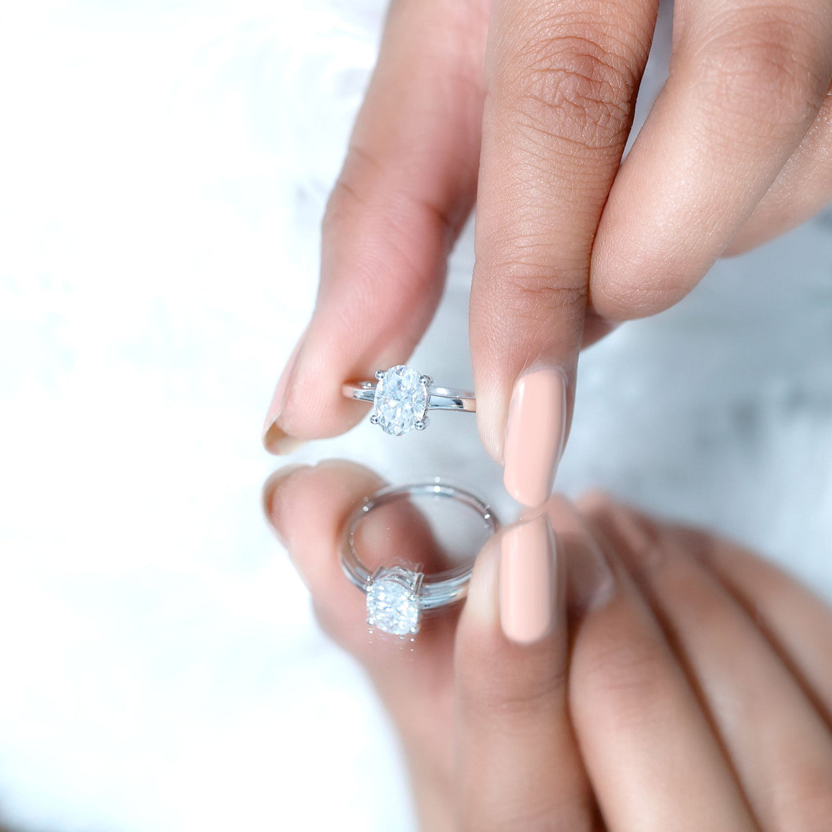 Certified 6x8mm oval moissanite solitaire engagement ring with a silver band from Rosec Jewels, close-up view of the ring.