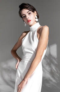 Elegant satin mini wedding dress by SelenaHuanStudio featuring a haltered neckline, open back, and thigh-high slit.