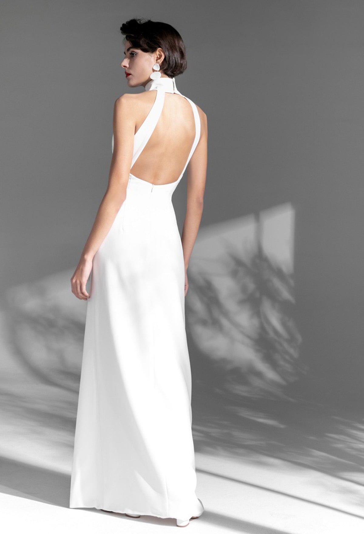 Elegant satin mini wedding dress by SelenaHuanStudio featuring a halter neckline, open back, thigh-high slit, perfect for special occasions