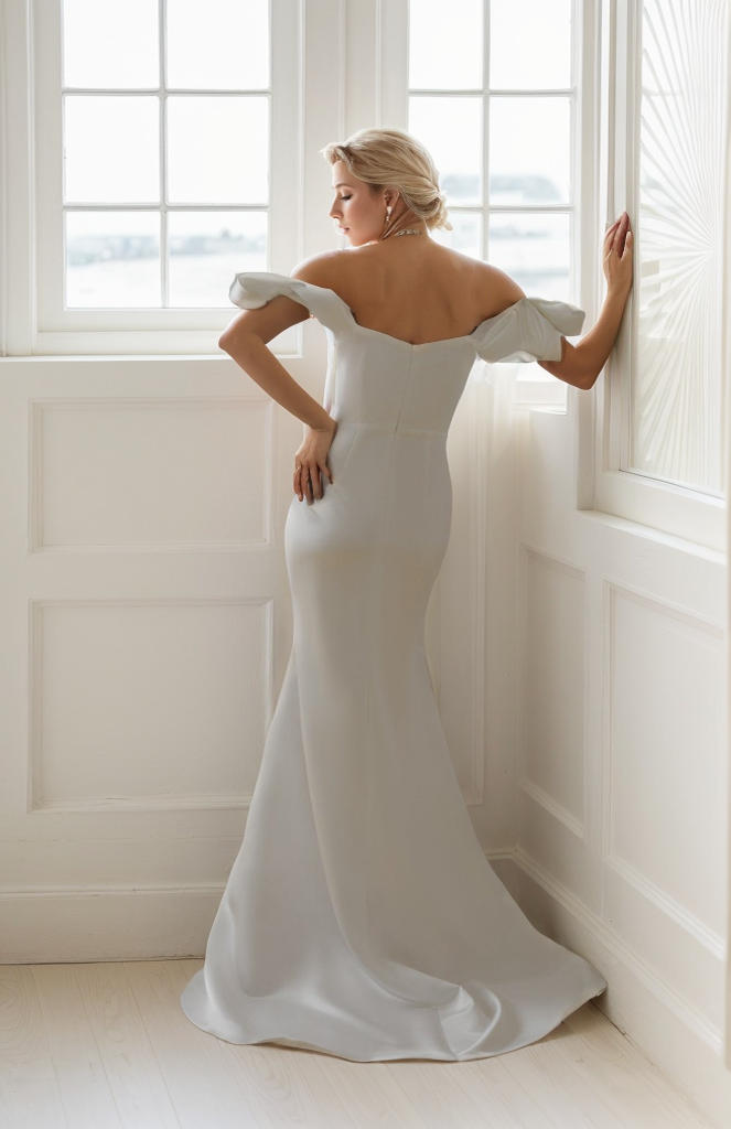 Elegant off-the-shoulder fit and flare duchess satin wedding dress with a simple design, perfect for a mini wedding celebration.