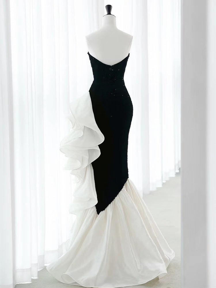 Black strapless sequin mermaid prom dress with ruffled organza accents by SelenaHuanStudio, showcasing a fitted silhouette and elegant design.