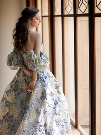 Elegant off-the-shoulder princess prom dress by SelenaHuanStudio with golden blue floral embroidery and flowing fabric.