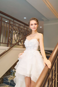SelenaHuanStudio Musa strapless white wedding dress with 3D floral lace, short-long skirt, and detachable sleeves for prom or special occasions.