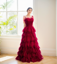 Elegant prom dress with spaghetti straps, pleated bodice, ruffle layers, and soft tulle skirt by SelenaHuanStudio.