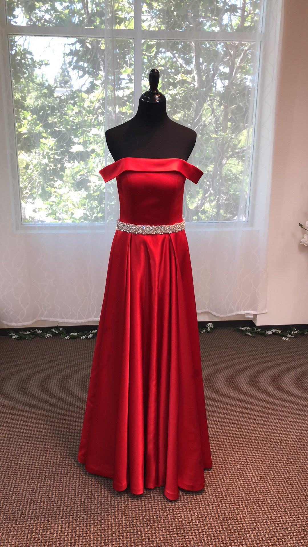 Off-shoulder ruby red satin prom dress with an A-line silhouette and crystal beaded sash, designed by SelenaHuanStudio.