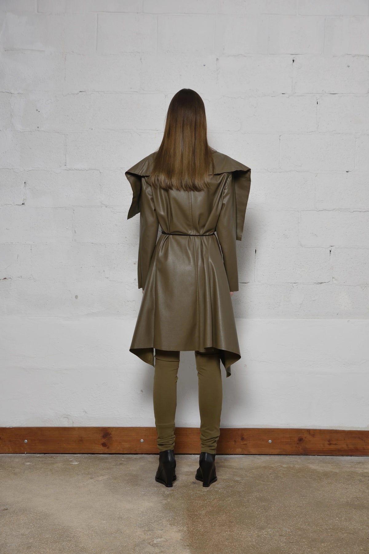 Simply Mila modern women's uneven coat in neutral fabric, displayed on a hanger with a textured, stylish design.