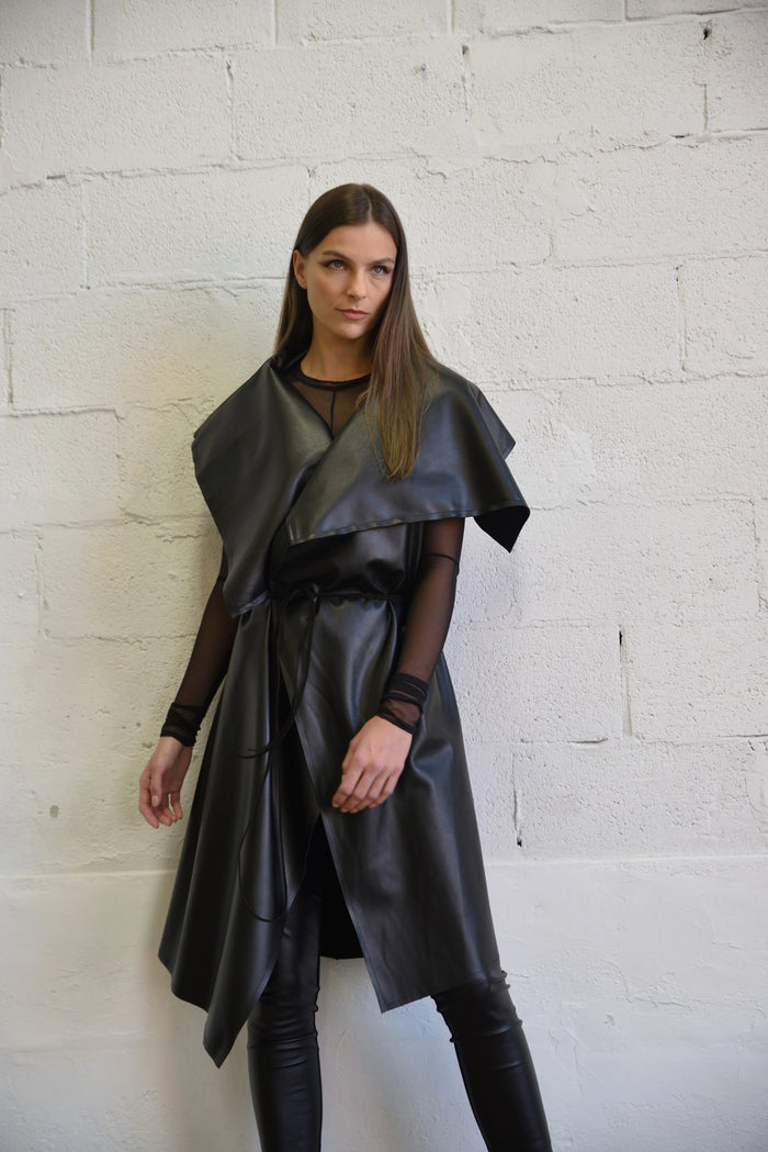 Uneven sleeveless coat by SIMPLY MILA, modern women's clothing, featuring a stylish asymmetrical design and tailored fit.
