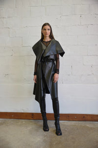 Uneven sleeveless coat by SIMPLY MILA, modern women's fashion, featuring a stylish asymmetrical design and neutral fabric.