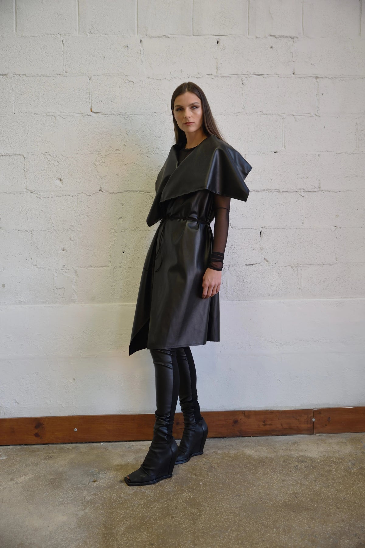 Uneven sleeveless coat from SIMPLY MILA Modern Women's Clothing, featuring a stylish, asymmetrical design and neutral color.