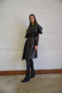 Uneven sleeveless coat from SIMPLY MILA Modern Women's Clothing, featuring a stylish, asymmetrical design and neutral color.