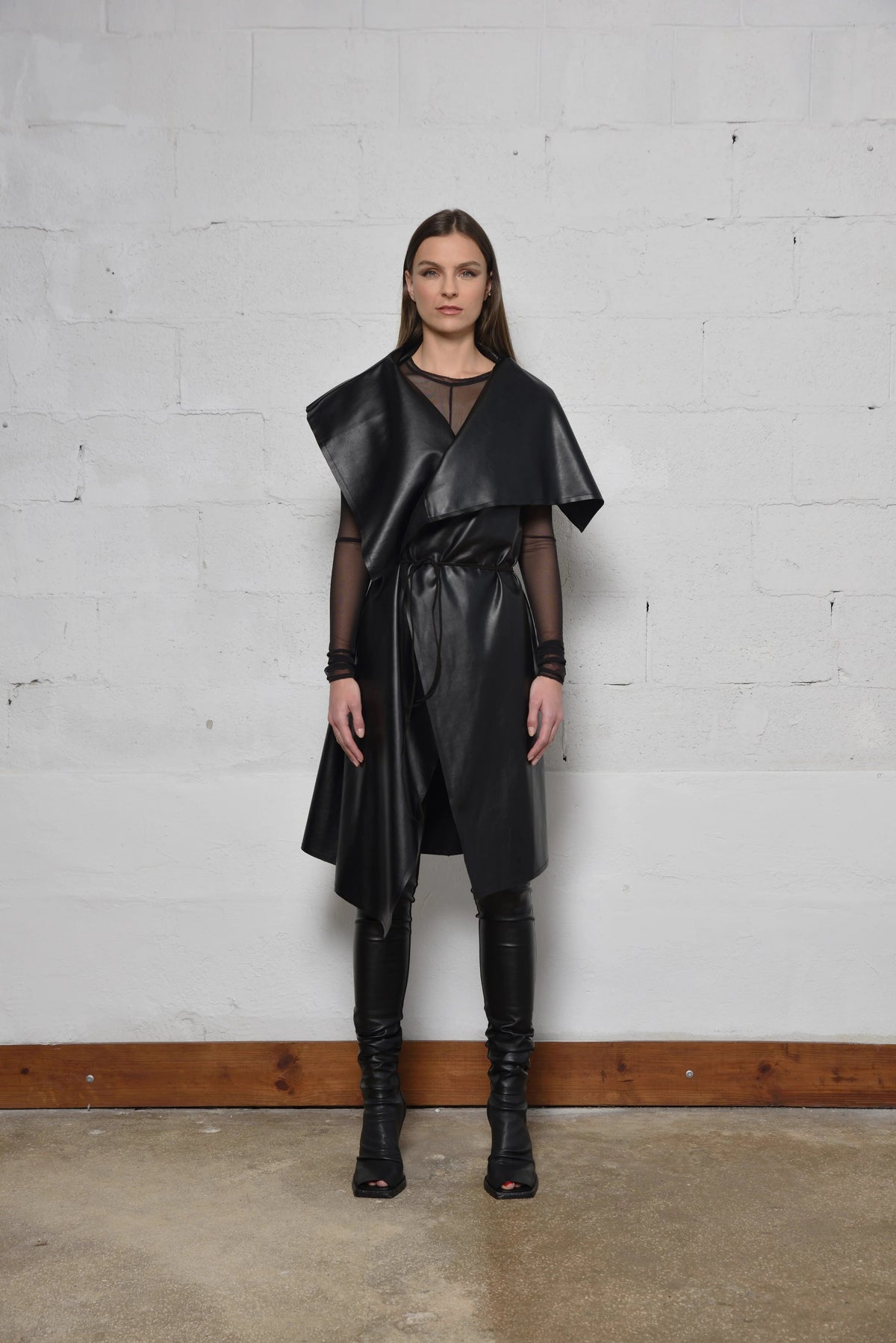 Uneven sleeveless coat by SIMPLY MILA, modern women's fashion, showcasing stylish asymmetric hem and tailored fit.