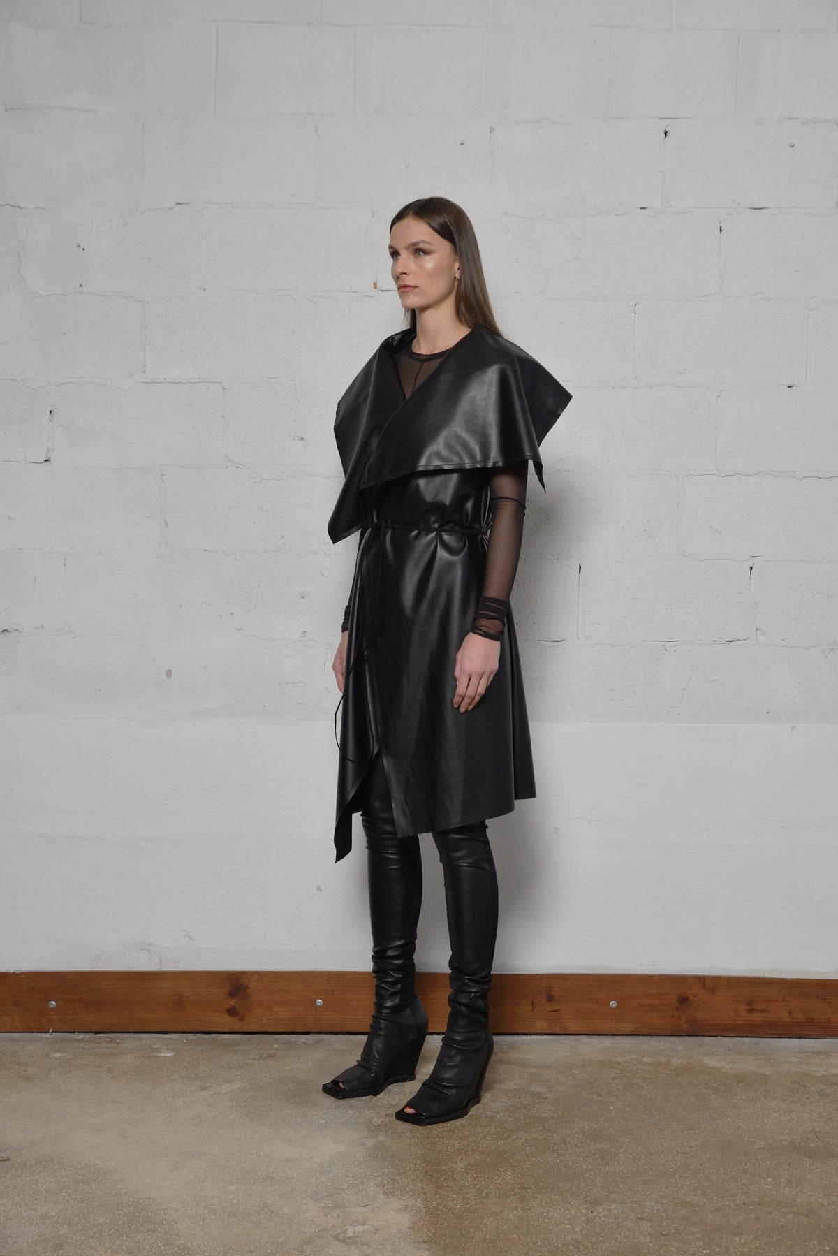 Uneven sleeveless coat by SIMPLY MILA, modern women's fashion, featuring a stylish cut and textured fabric in a contemporary design.
