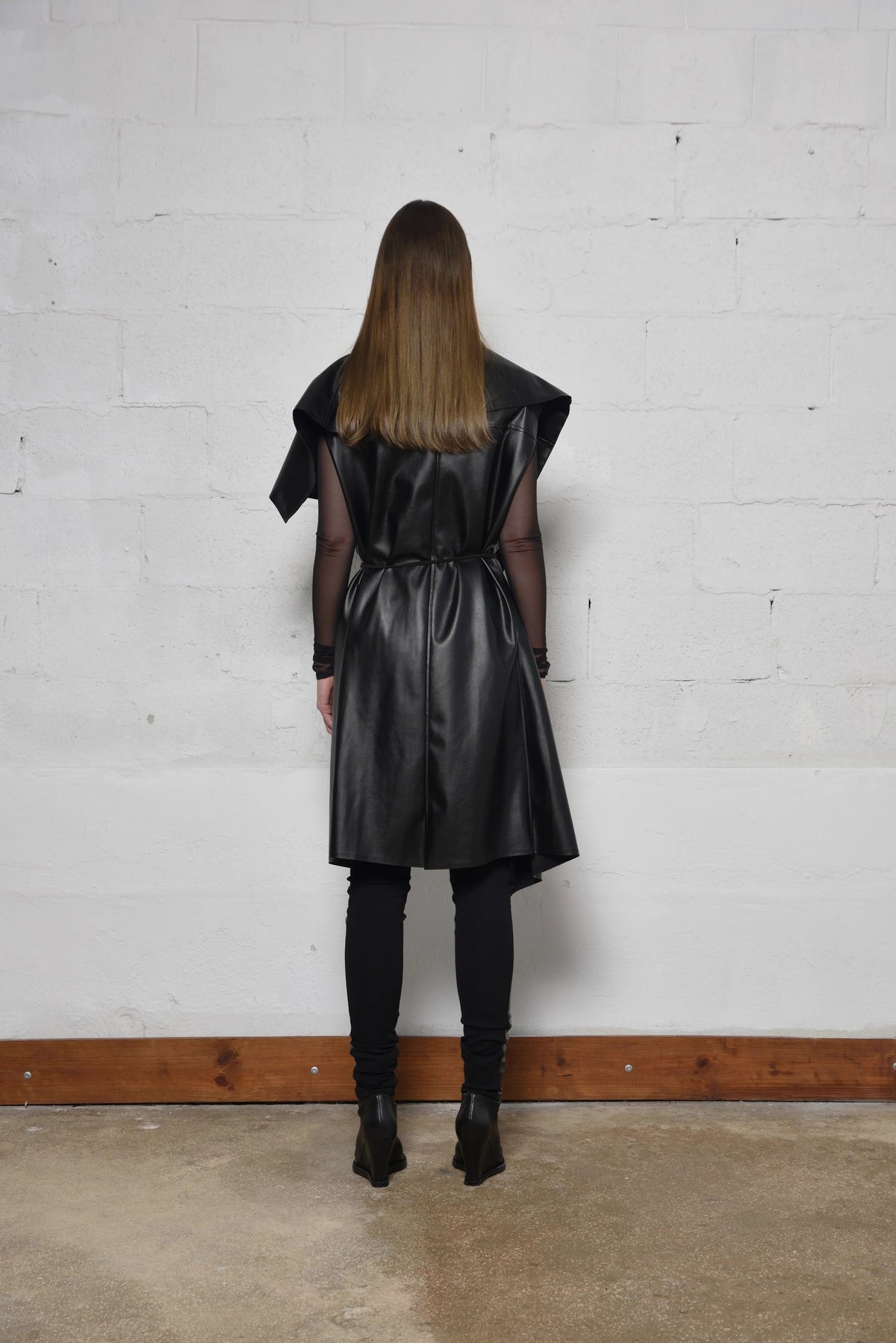 Uneven sleeveless coat by SIMPLY MILA, modern women's fashion, shown on a model with stylish silhouette and textured fabric.