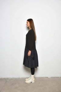 Side view of a stylish Dune dress by SIMPLY MILA Modern Women's Clothing, featuring a flattering fit and contemporary design.