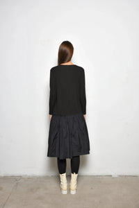 Back view of a stylish Dune dress by SIMPLY MILA Modern Women's Clothing, featuring a flowing design and elegant silhouette.