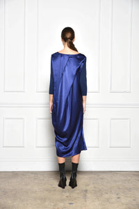Back view of a stylish draped dress by SIMPLY MILA Modern Women's Clothing, showcasing elegant fabric and modern design.