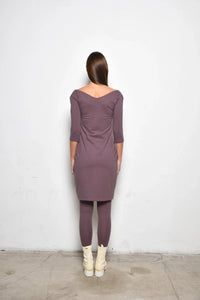 Simpy Mila Berlin dress for women, stylish and elegant, displayed on a hanger with floral pattern fabric.