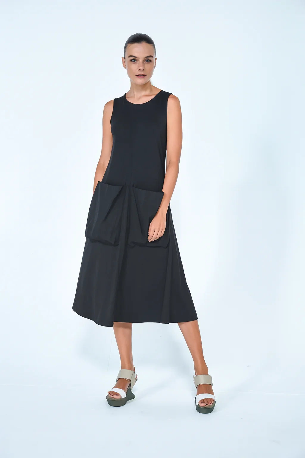 Black Big Pocket dress from SIMPLY MILA Modern Women's Clothing, shown on a model, featuring a relaxed fit and prominent front pockets.