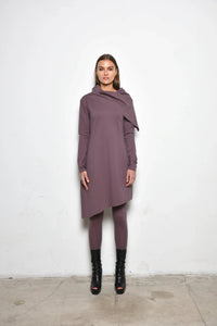 Simply Mila Amsterdam dress, modern women's dress in a stylish design, shown on a hanger with a vibrant pattern.
