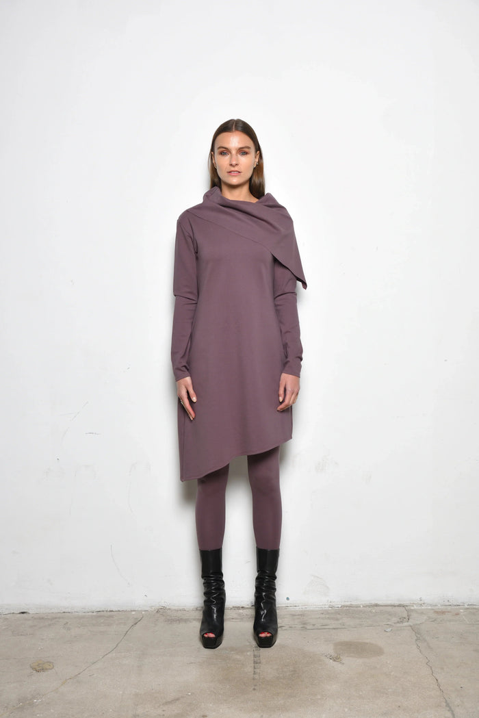Simply Mila Amsterdam dress, modern women's dress in a stylish design, shown on a hanger with a vibrant pattern.