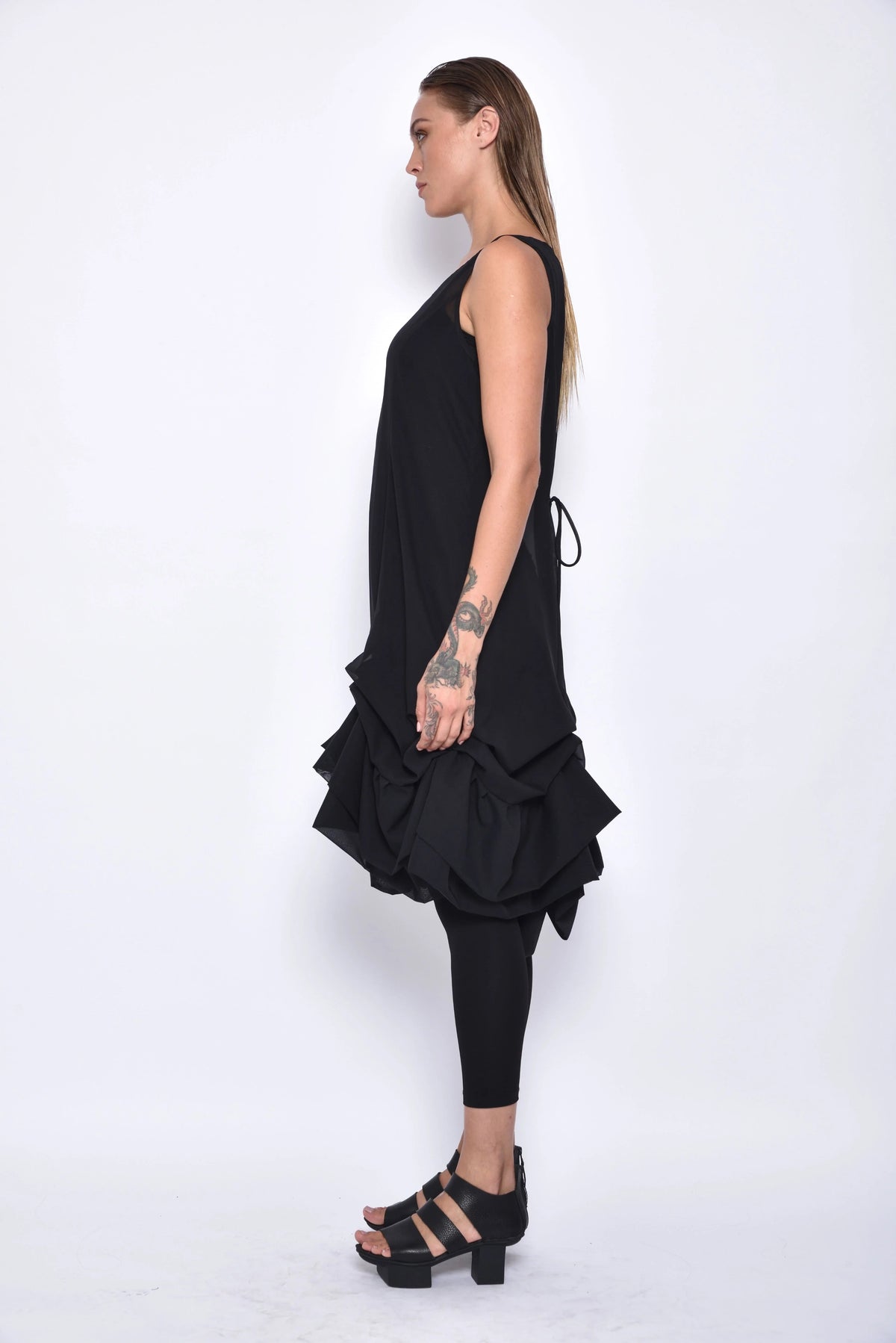 Side view of a stylish Aura dress by SIMPLY MILA Modern Women's Clothing, showcasing its elegant design and fabric details.