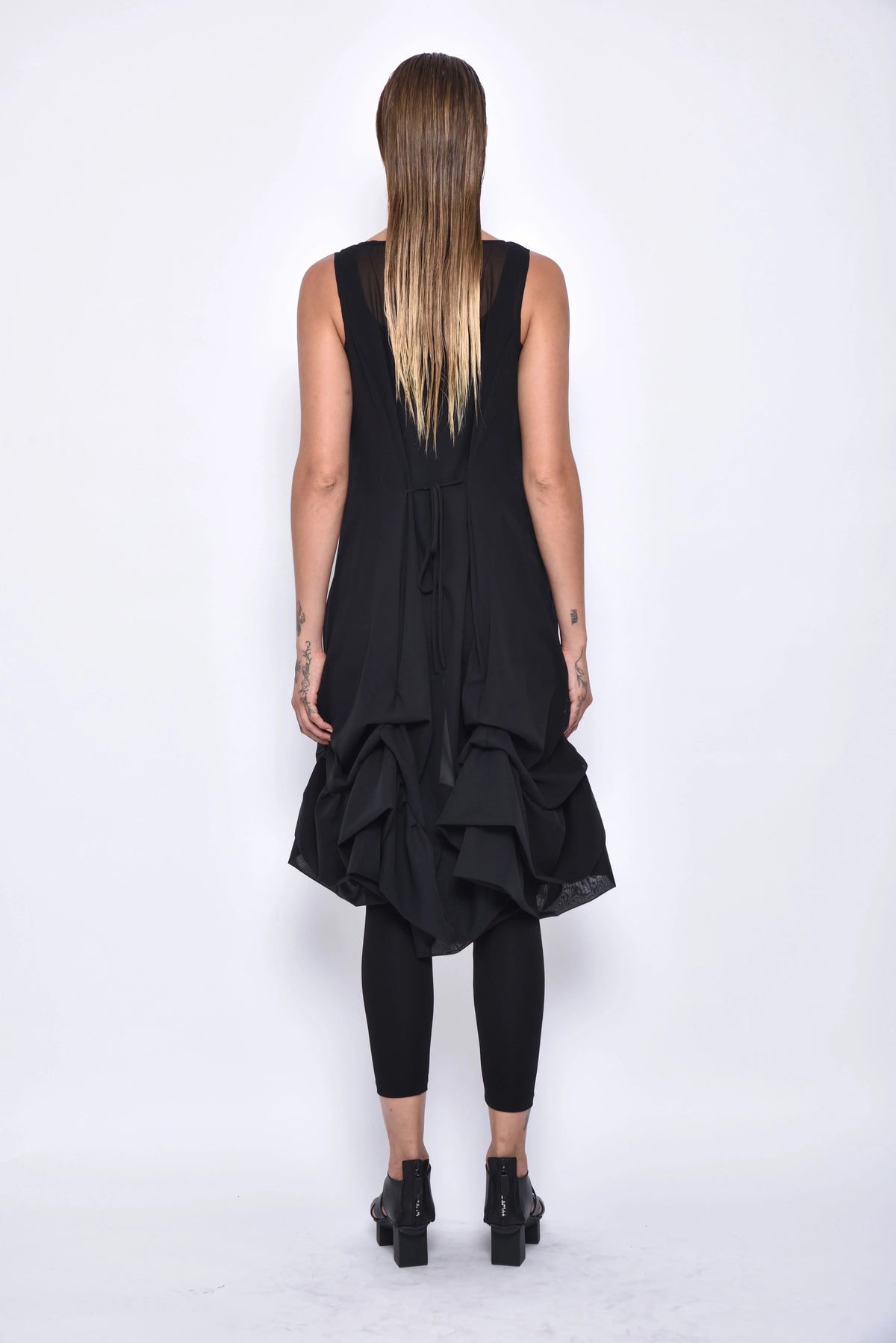 Back view of a stylish Aura dress by SIMPLY MILA Modern Women's Clothing, featuring a flowing design and elegant fit.