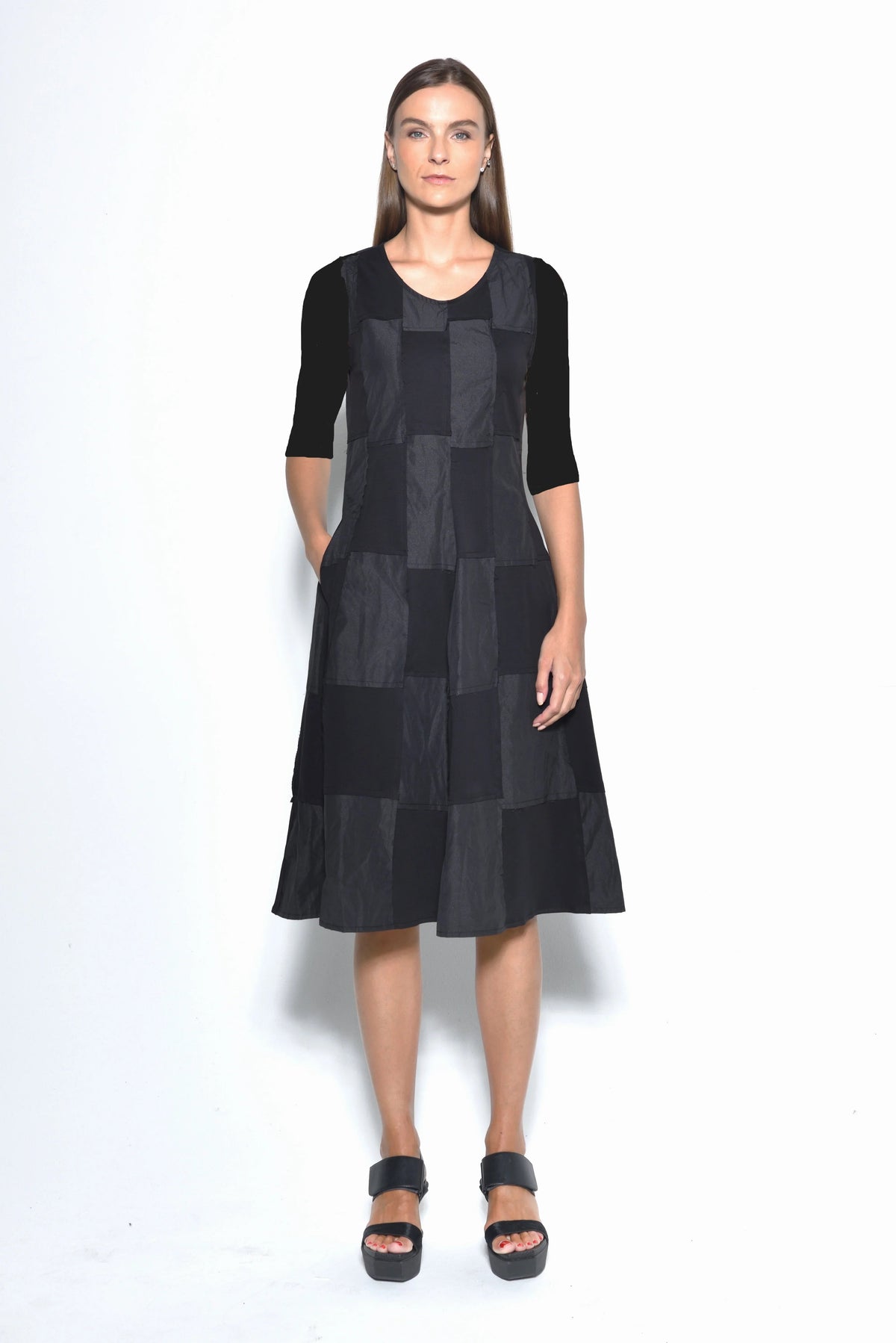 Front view of a stylish chessboard patterned dress by SIMPLY MILA Modern Women's Clothing, featuring a fitted silhouette and knee-length design.