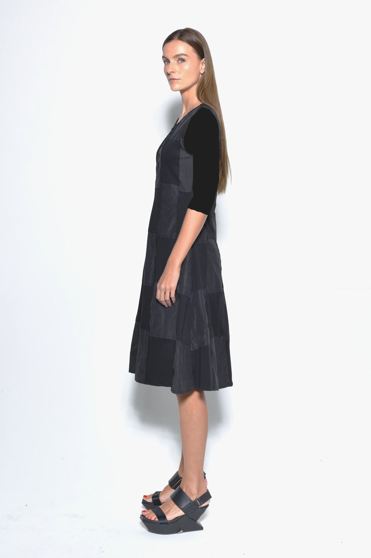 Side view of a stylish Chessboard dress by SIMPLY MILA Modern Women's Clothing, featuring a black and white checkered pattern.