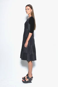 Side view of a stylish Chessboard dress by SIMPLY MILA Modern Women's Clothing, featuring a black and white checkered pattern.