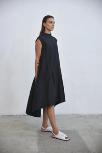 Black Gaia dress by SIMPLY MILA Modern Women's Clothing, showcasing a stylish, flowy dress with a fitted waist and elegant design.