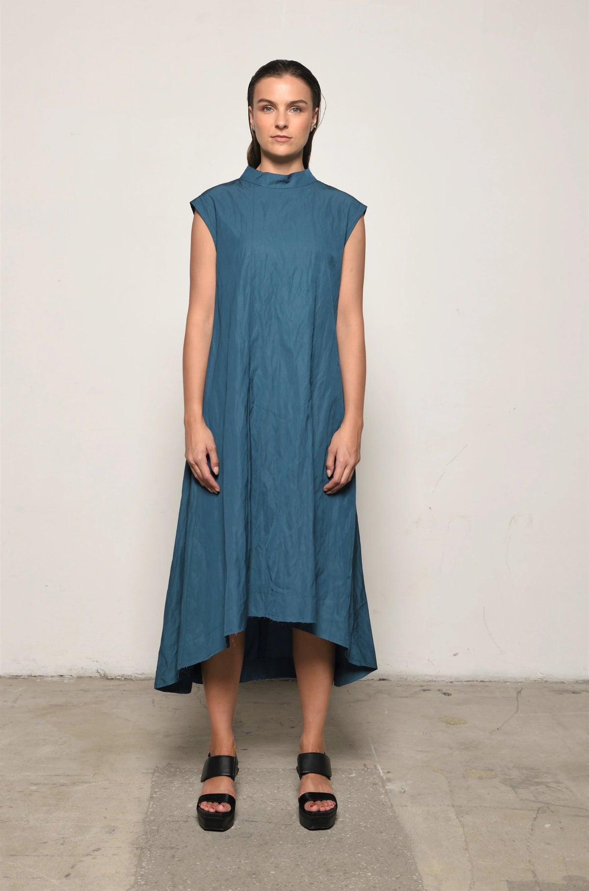 Light blue Gaia dress by SIMPLY MILA Modern Women's Clothing, flowing fabric and stylish design, displayed on a hanger.