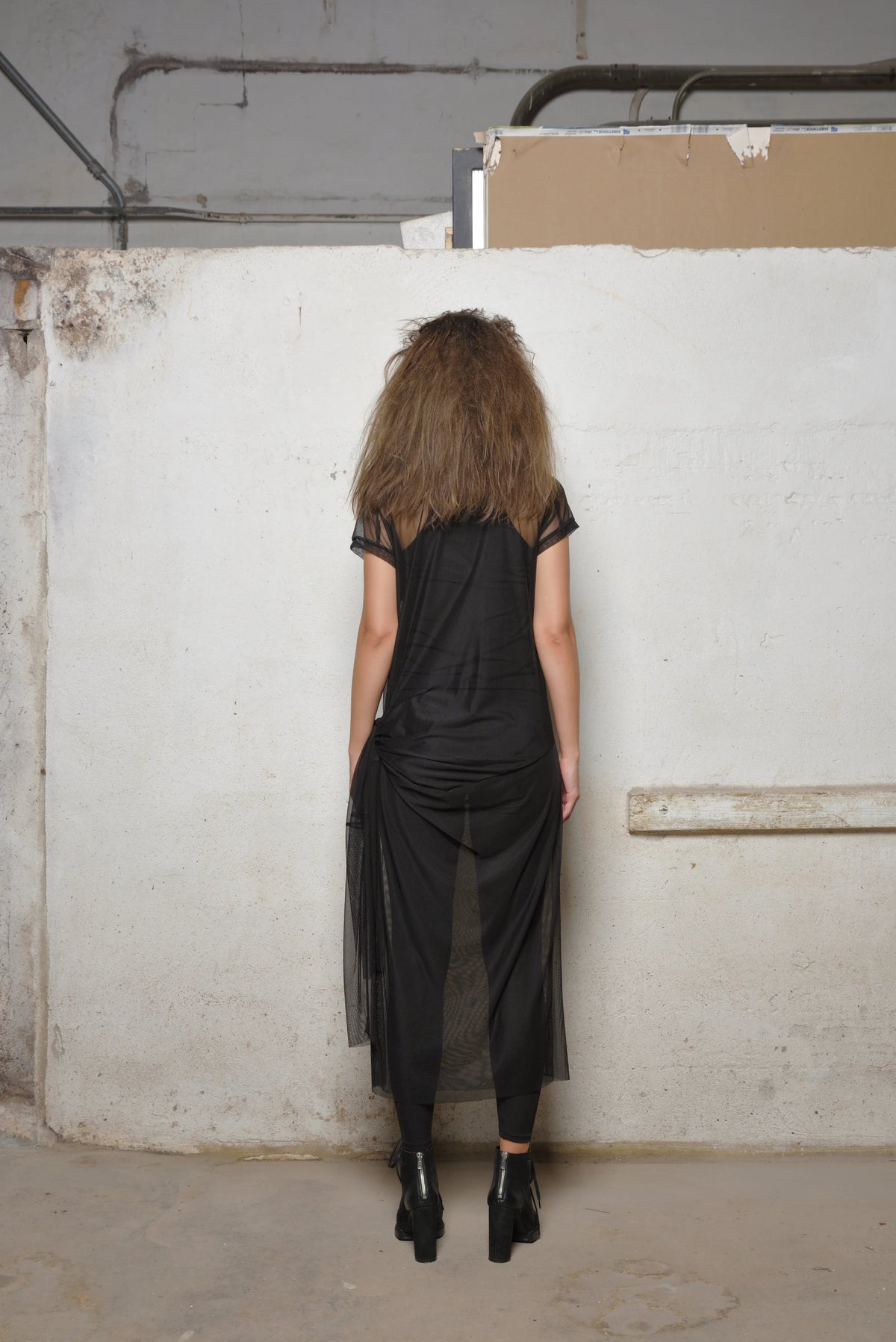 Black mesh dress from SIMPLY MILA Modern Women's Clothing, featuring a stylish, semi-sheer design perfect for modern fashion.
