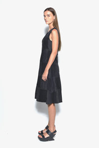 Side view of a sleeveless chessboard dress by SIMPLY MILA Modern Women's Clothing, featuring a black and white checkered pattern.