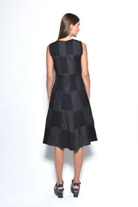 Back view of a sleeveless chessboard dress from SIMPLY MILA Modern Women's Clothing, featuring a stylish black and white checkered pattern.