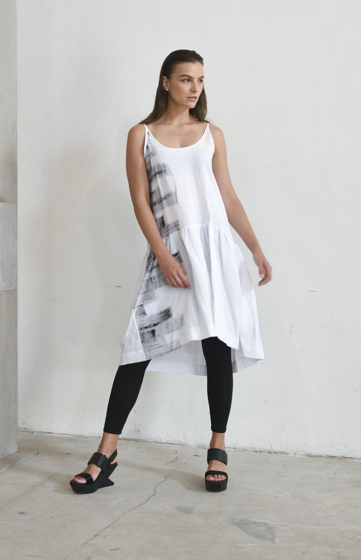 White linen peplum dress for women, stylish and breathable, from SIMPLY MILA Modern Women's Clothing, displayed on a hanger.