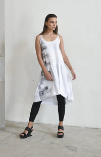 White linen peplum dress for women, stylish and breathable, from SIMPLY MILA Modern Women's Clothing, displayed on a hanger.