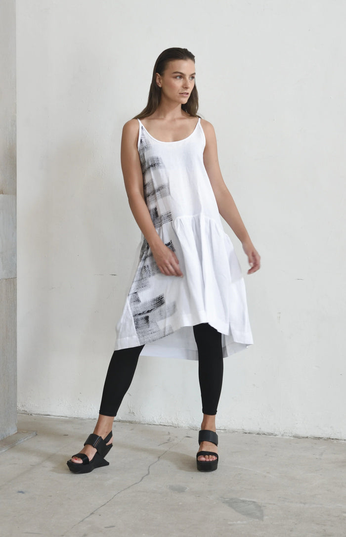 White linen peplum dress for women, stylish and breathable, from SIMPLY MILA Modern Women's Clothing, displayed on a hanger.