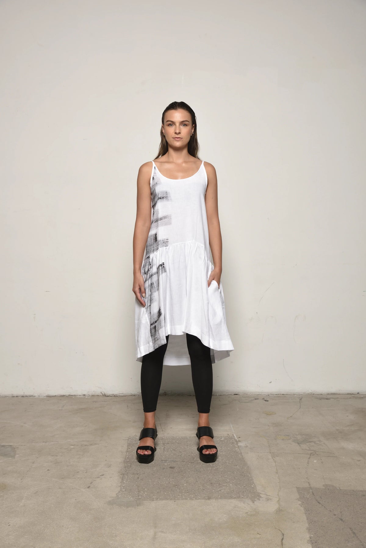White linen peplum dress by SIMPLY MILA Modern Women's Clothing, front view showing fitted waist and flared skirt.